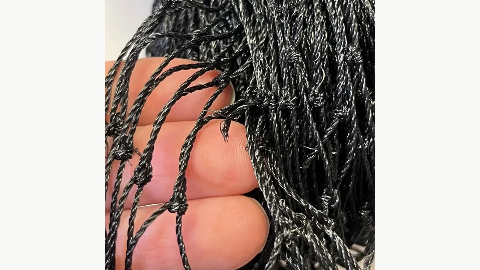 Approved black wire-reinforced cat net used to verify the product entity behind a packaging proof