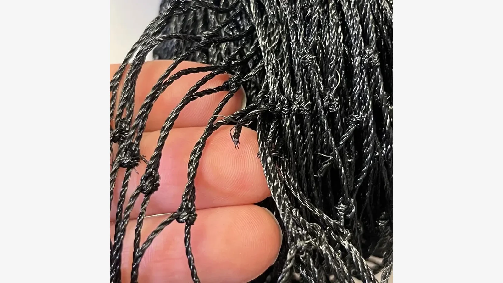 Black stainless-steel wire-reinforced cat-net mesh detail